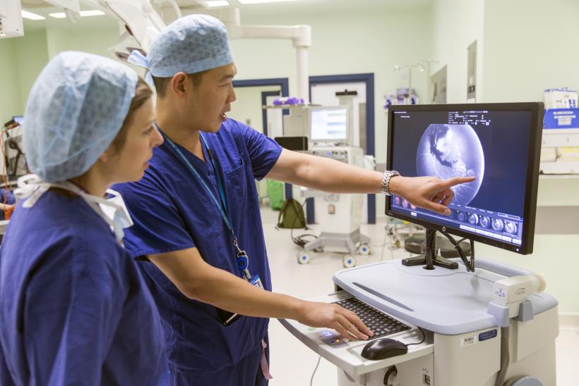 Mr Chien Wong using a RetCam device to review a patient's eye